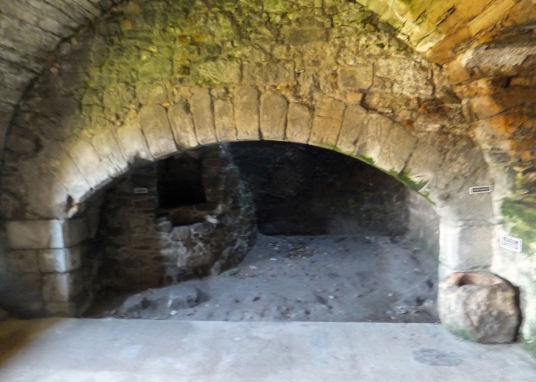 Kitchen fireplace, Aberdour Castle, a scenic old stronghold castle with gardens and orchard of the Douglas Earls of Morton, in the pretty village of Aberdour in Fife.